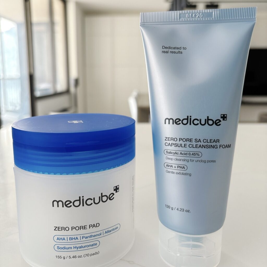 Best 5 Medicube Products: The One Item I Can't Live Without Five Medicube bestseller products including Zero Pore Pads, Zero Pore Capsule Cleansing Foam, Kojic Serum, Collagen Jelly Cream, and PDRN Milky Toner arranged on a white skincare shelf