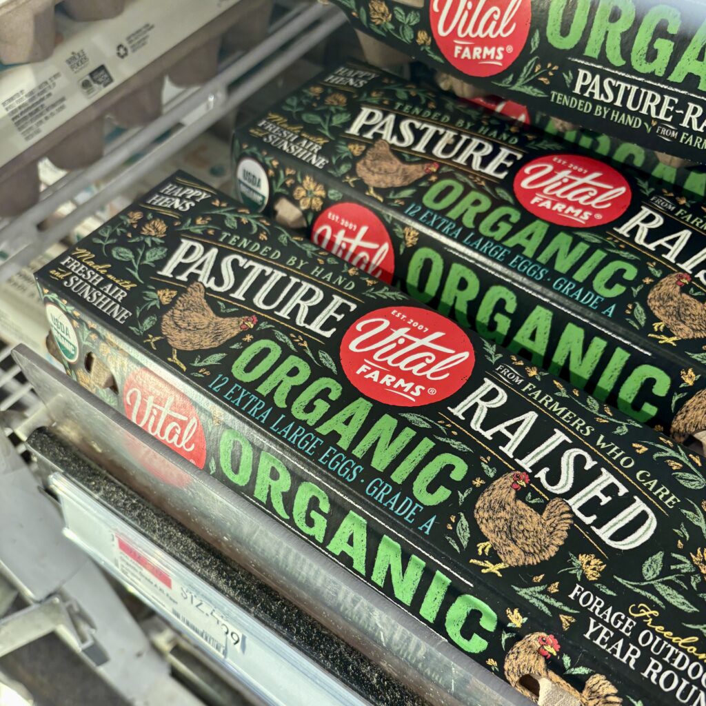 Vital Farms Pasture-Raised Organic Eggs in a black carton with Happy Hens logo