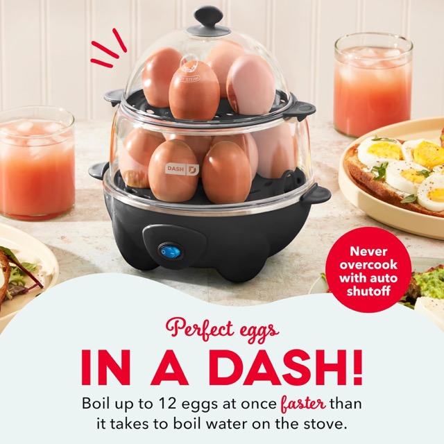Five electric egg cookers lined up on a kitchen counter including Dash, Elite Gourmet, and VOBAGA stainless steel models