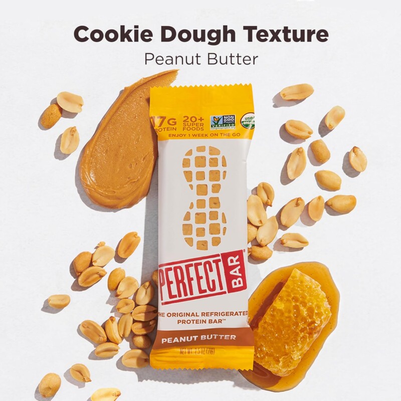 Two flavors of Perfect Bar refrigerated protein bars — Peanut Butter and Dark Chocolate Chip Peanut Butter — on a kitchen counter next to a Costco box