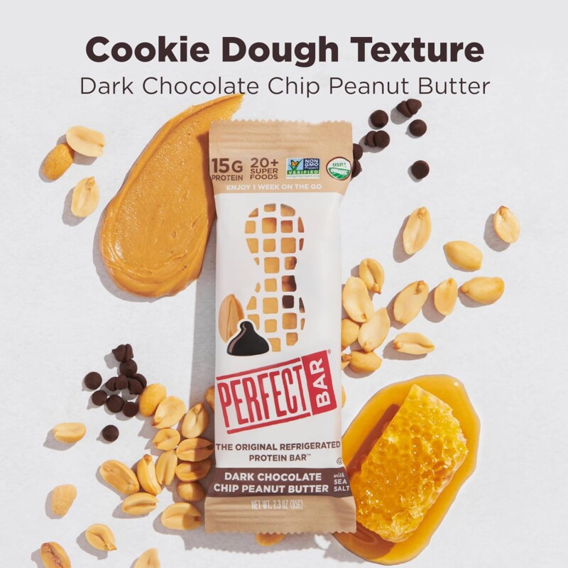 Two flavors of Perfect Bar refrigerated protein bars — Peanut Butter and Dark Chocolate Chip Peanut Butter — on a kitchen counter next to a Costco box