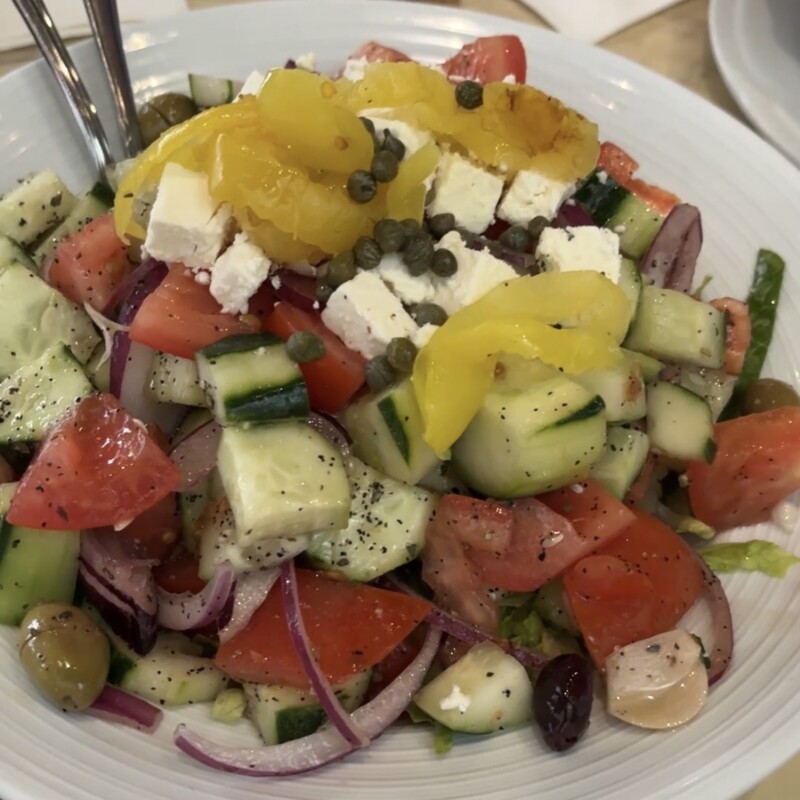 Fresh Greek Horiatiki salad with feta cheese, olives, and cucumbers at Greek Tavern