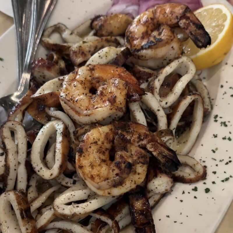 Grilled seafood sampler featuring octopus, squid, and shrimp at Edgewater Greek Taverna
